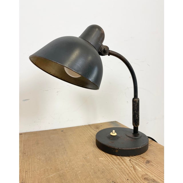 Black Bauhaus table lamp made in Germany by Siemens during the 1930s. The lamp has an adjustable metal shade, an iron base...