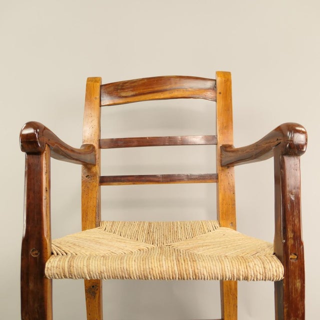 Beautiful old armchair made of cherry wood. A real handcrafted journey through time: The chair joints were fixed with...