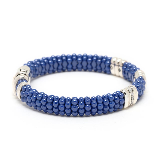 Stones: blue ultramarine beads diamond round brilliant cut .28 btw GH color/ SI1-2 clarity Circumference: 6.5 in. Width:...