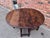 This finely crafted antique gateleg table is constructed of solid English oak with a rich, deep patina developed over...