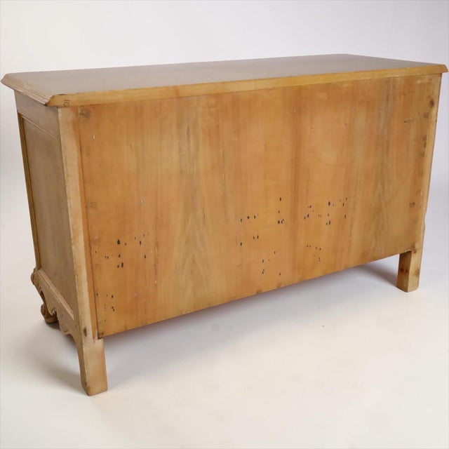 It is an Italian French Louis XV style carved pine three drawer commode. It has an elaborately carved front with floral...