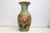 Our vase is has a detailed hand-painted Floral motif with a butterfly over a light green toned surface. The curved form is...