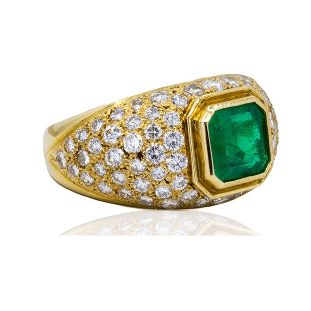 18k Ring with one bezel set 1.65 carat Colombian emerald and 74 pave set round brilliant diamonds weighing 2.76 carats....