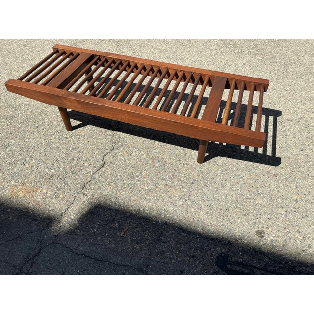 Mid century solid walnut bench in manner of Milo Baughman for Glenn of California. The bench is in excellent condition....