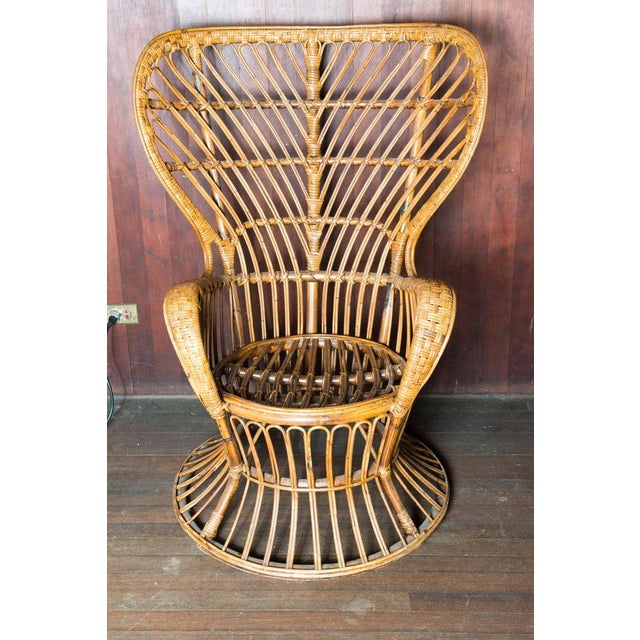 Mid-Century Modern vintage rattan wingback arm chair in the style of the Gio Ponti chair designed circa 1948 in Italy and...