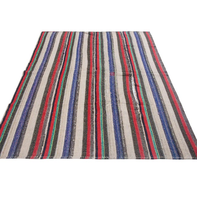 Striped vintage handwoven kilim rug from Adana region of Turkey. Approximately 50-60 years old. In very good condition.