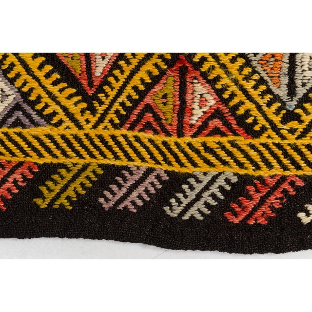 This is a vintage Turkish Oushak rug from the Mid 20th Century. The piece was hand-knotted.