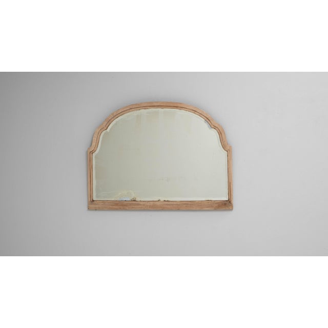 This 1900s French oak mirror features a beautifully contoured arched frame that highlights the quiet elegance of...