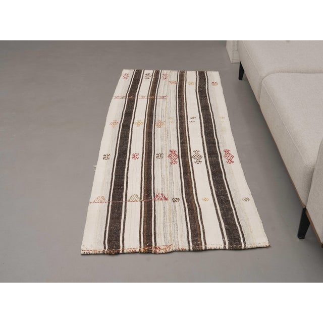 Vintage Hand-Knotted runner rug is a semi-antique vintage area rug. The '70s Eastern region of Anatolia's unique rug is...
