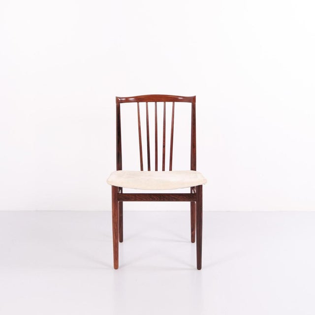 Set of four dining chairs designed by henning sørensen in 1968. Crafted in rosewood with light fabric upholstery. The...