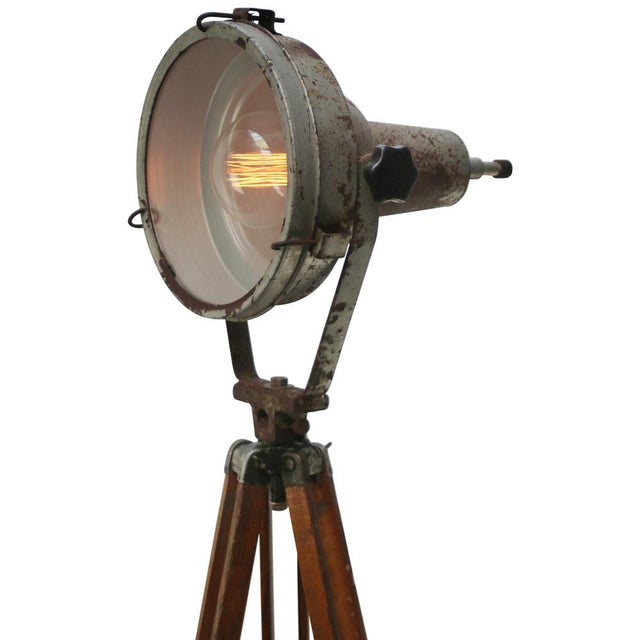 Vintage industrial spotlight on wooden tripod. adjustable height and angle. grey iron spot with clear glass. Diameter 30...