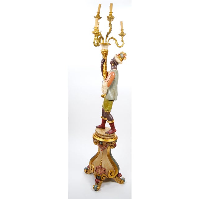 Transform your space with this breathtaking Italian figural standing candelabra floor lamp, a masterpiece of early 20th-...