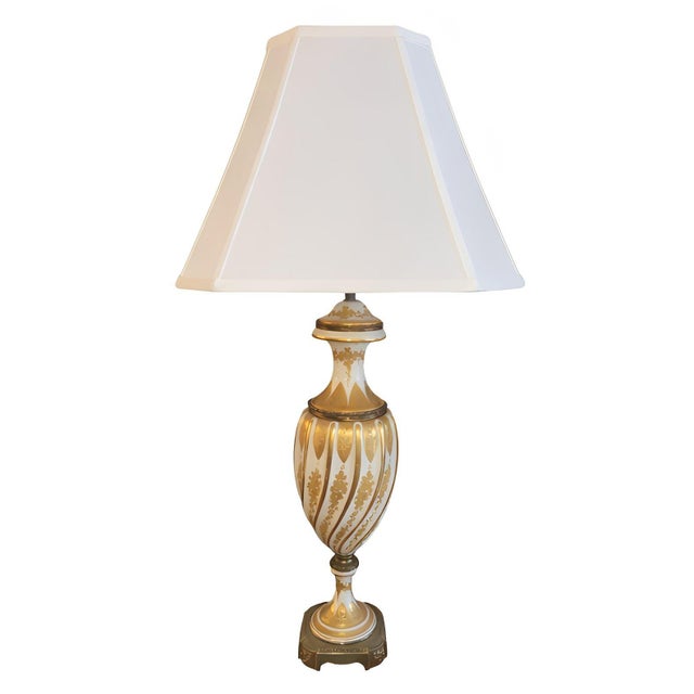 An elegant and finely executed pair of Sèvres style porcelain table lamps, decorated on a luminous white ground with rich...