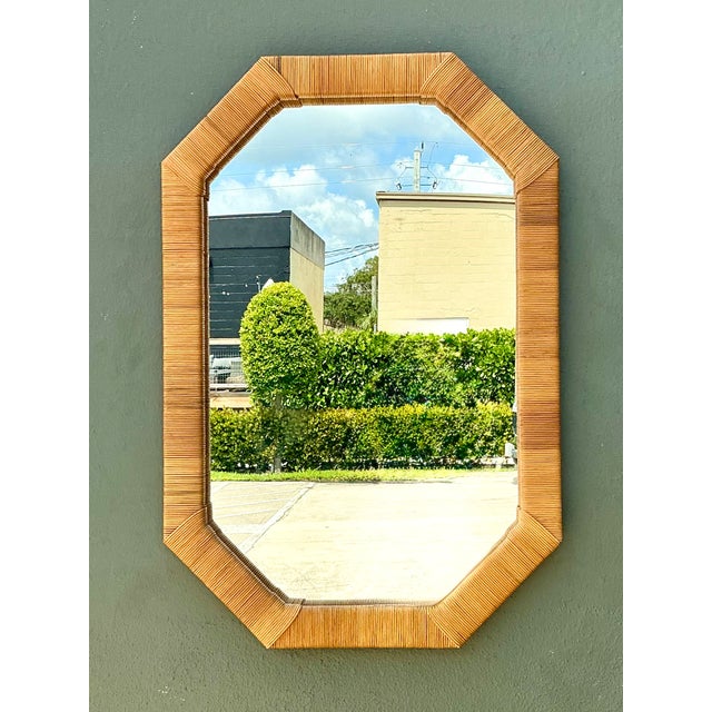 This vintage octagonal wall mirror showcases the timeless appeal of natural materials through its beautifully wrapped...