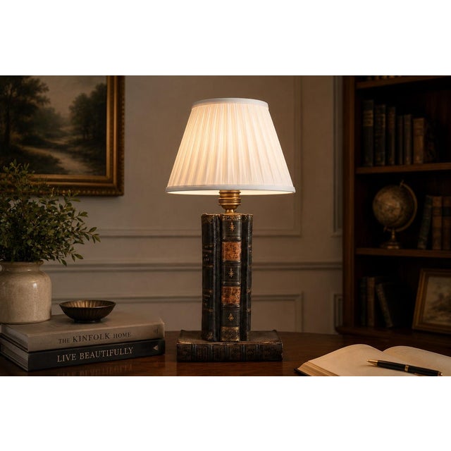 A wonderfully characterful vintage table lamp crafted from a stack of antique leather-bound books with rich gilt spine...