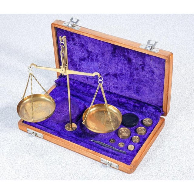 Portable two-pan balance, made of bronze, with weights. 20th century period 20th century materials metal, wooden case...