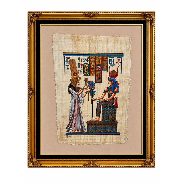 Colorful Egyptian Revival artwork depicting a standing royal figure presenting offerings to a seated goddess beneath rows...