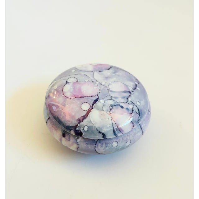 A lovely vintage circular ceramic lidded box. Lovely hand painted abstract design to the glaze in shades of purple with a...