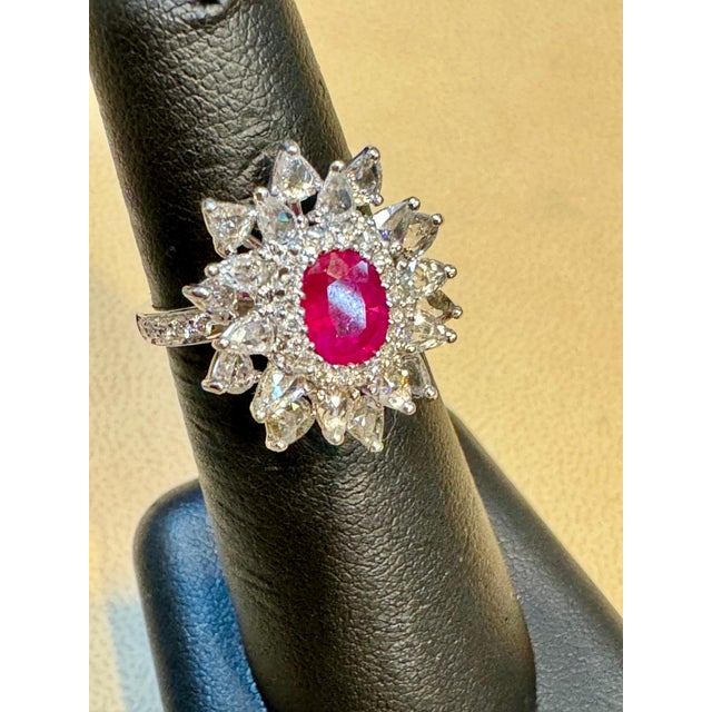 Introducing our exquisite 18 Karat Gold Ring, featuring a stunning 1.1 carat natural oval Ruby and approximately 2 carats...