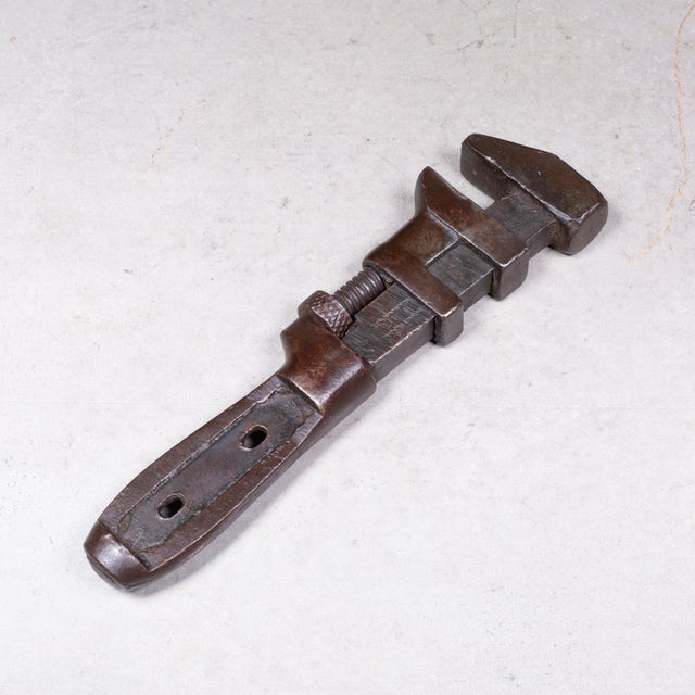 ABOUT A 19th century cast iron adjustable wrench. Maker's mark stamped on the side. CREATOR Unknown. DATE OF MANUFACTURE...