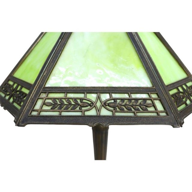 This antique Pittsburg Arts & Crafts table lamp, dating to approximately 1920, features an eight-panel slag glass shade....