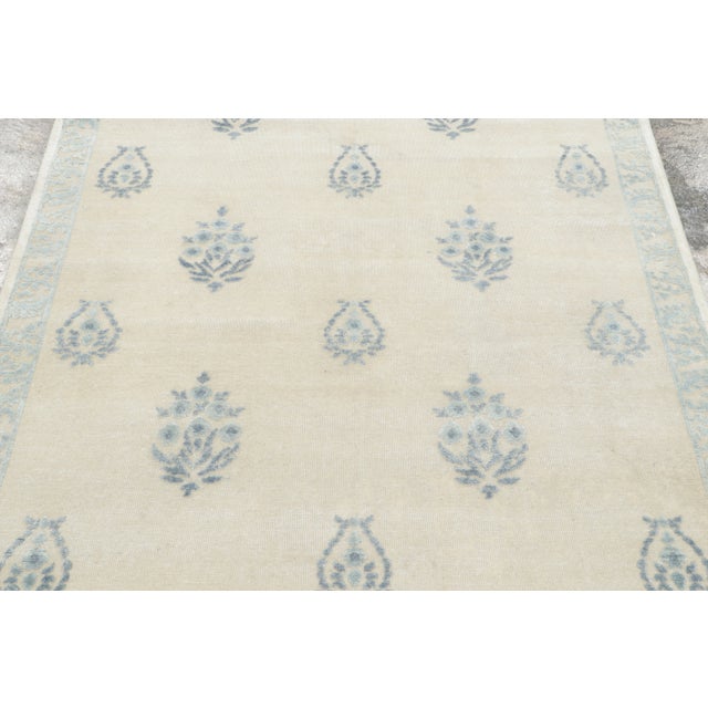 Hand-knotted in natural silk, this contemporary 4x5 Block Print rug features delicate blue floral sprigs and paisley-...