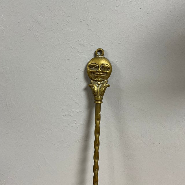 This vintage English brass toasting fork is adorned with a charming "Man in the Moon" motif at the top, showcasing...
