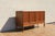 Exceptional mid-century modern walnut sideboard credenza by Dunbar, dating from the 1970s. This elegant piece showcases...