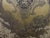 A woven textile piece featuring a prominent Medusa portrait surrounded by classical putti and intricate acanthus...