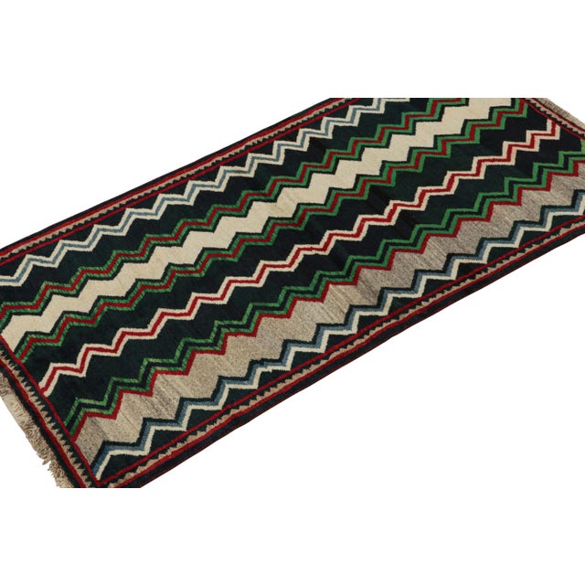 This vintage 3x6 Persian runner is a Gabbeh rug that originates from the Qashqai tribe—hand-knotted in wool circa...