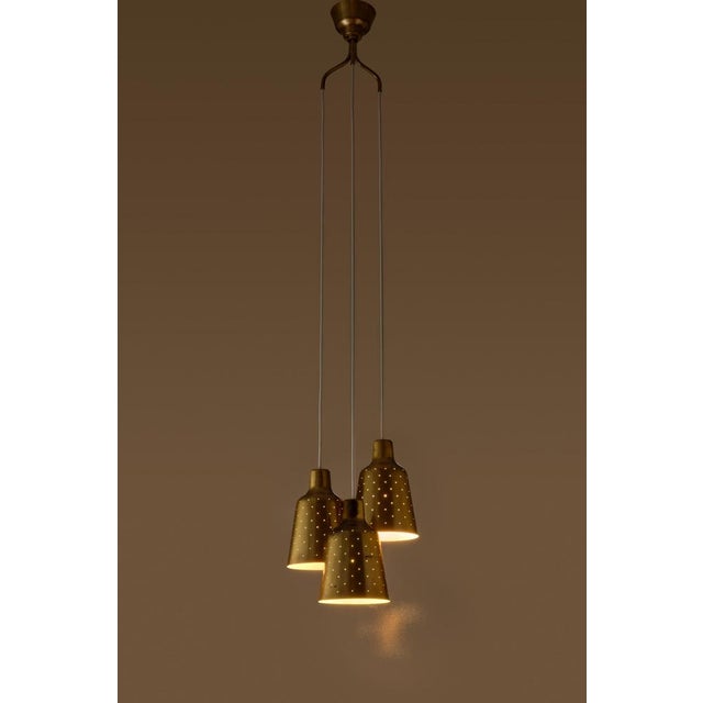 Rare model. Produced by Ateljé Lyktan, Åhus, Sweden, 1950s. Rewired. Height is adjustable. Perforated brass. This piece is...