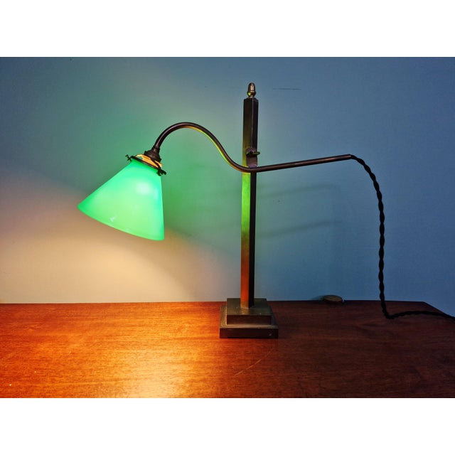 Magnificent articulated bronze desk lamp with a conical green opaline shade, 1920s. More commonly known as a notary's lamp...