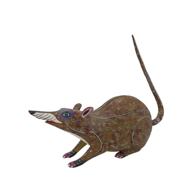 Hand-carved and hand-painted Oaxacan Alebrije figurine depicting a shrew or mouse with a slender, upturned tail. Hand...