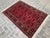 Enhance your home with this stunning hand-knotted wool rug, featuring a vibrant red floral and geometric design. The...