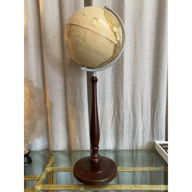 Beautiful and stylish vintage wood footed, soft tan colored terrestrial globe. National Geographic 2009. Made in USA.