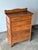 This antique dresser features scalloped detailing at both the shaped backsplash and apron, with five graduated dovetailed...