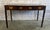 A superb and authentic antique British Colonial Campaign console desk, embodying the refined utilitarian elegance of 19th-...