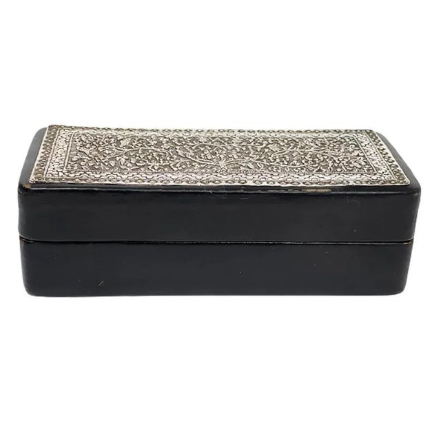 Black leather with Indonesian silver 1920s box A rectangular box in black leather with Indonesian silver on top of the lid...