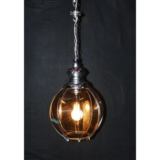 A distinctive mid-century pendant light dating to circa 1960s, featuring a striking geometric globe constructed from...