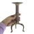 Single brass and copper pillar candle holder with three legs, some corrosion, scratches and patina, shown in the photos....