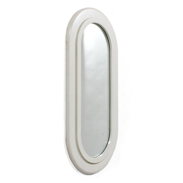 This playful pill-shaped 1970s mirror by Sryoco has a white frame and is perfect for a bedroom, bathroom, or entry. Also...