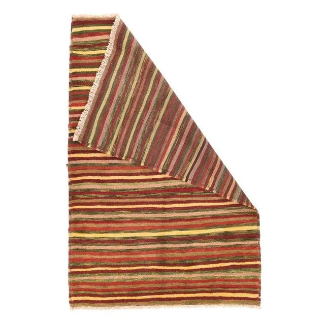 Probably created from piles of leftover yarns from more considered creations, this Qashghai nomadic scatter show...