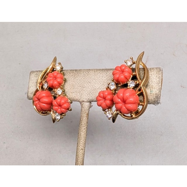 Mid to late 1950s goldtone coral colored resin melon shaped rhinestones with clear round rhinestone accents clip earrings....