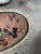 A beautiful handmade antique Chinese Art Deco rug from the 1920s, featuring a refined oval shape and an elegant floral...