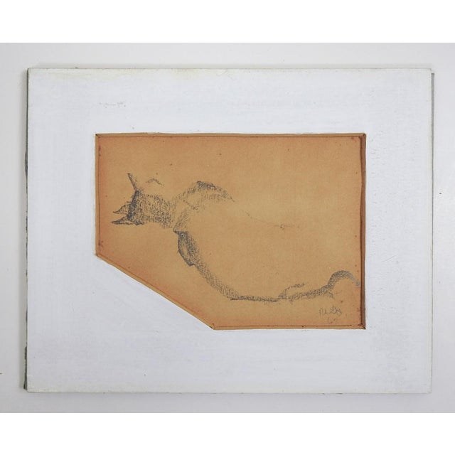 Small 1967 pencil on tan paper drawing of a sleeping cat. Signed illegibly and dated lower right. Unframed, displayed...