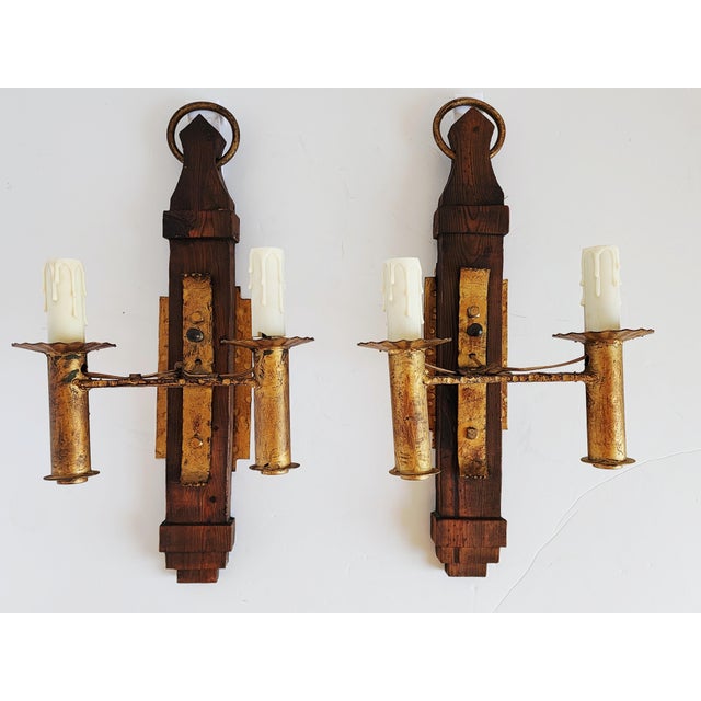 Stunning and very unique Mid-Century Spanish Revival style wall sconces, featuring a large wood frame with gilded wrought...