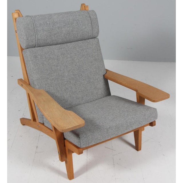 Hans j. Wegner lounge chair with loose cushions new upholstered with grey hallingdal wool from kvadrat. Frame of oak. With...