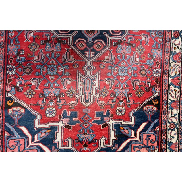 Immerse yourself in history with the Handmade Vintage Persian Bidjar Rug from the 1960s. Design and Aesthetics: Dating...