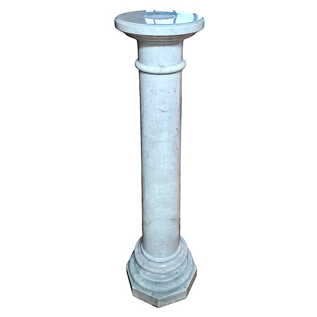 On offer is a solid marble pedestal in the Neoclassical style featuring a three-piece design with a cylindrical body,...