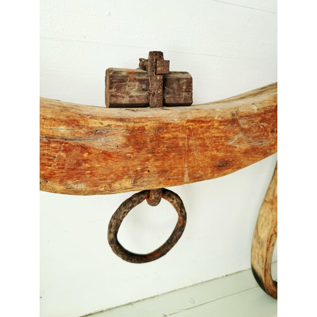 An exceptional 19th-century American double ox yoke, hand-hewn from a single massive hardwood timber and retaining its...